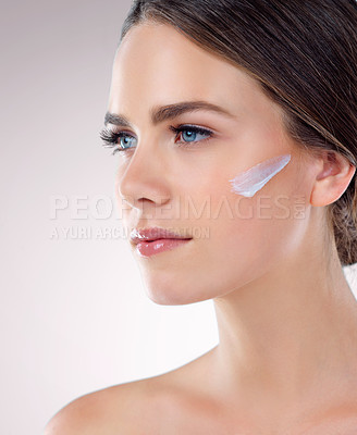 Buy stock photo Face cream, thinking or woman with skincare in studio on white background for foundation, glow or shine. Facial lotion, girl model with sunscreen, beauty idea or cosmetics results in Germany