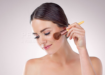 Buy stock photo Woman, powder brush and apply makeup in studio, skincare and cosmetics tool for highlighter. Female person, facial treatment and white background for beauty, foundation transformation and blush