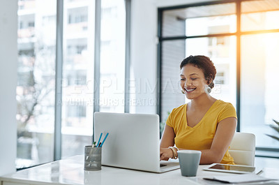 Buy stock photo Shot of a young designer working on a laptop in an office
