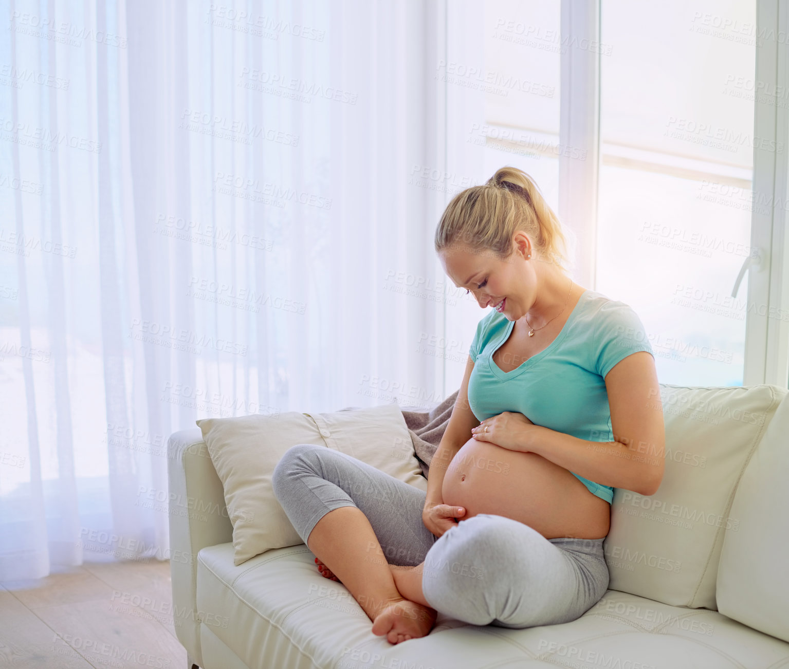 Buy stock photo Mother, smile and pregnant woman on sofa in home holding belly for maternity care with happiness. Love, relaxing and maternal female person from Australia touch stomach in living room at apartment.