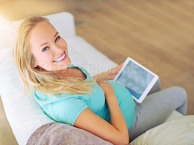 Buy stock photo Portrait of a pregnant woman using a digital tablet at home