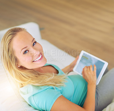 Buy stock photo Portrait of a pregnant woman using a digital tablet at home