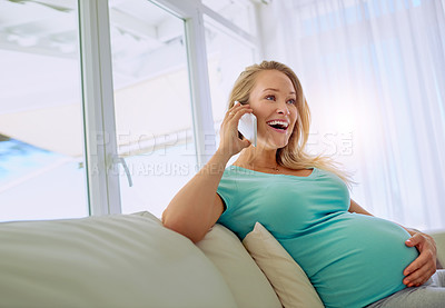 Buy stock photo Shot of a pregnant woman talking on a cellphone at home