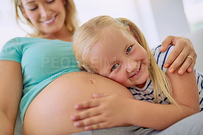 Buy stock photo Portrait of a little girl hugging her mother's pregnant belly at home