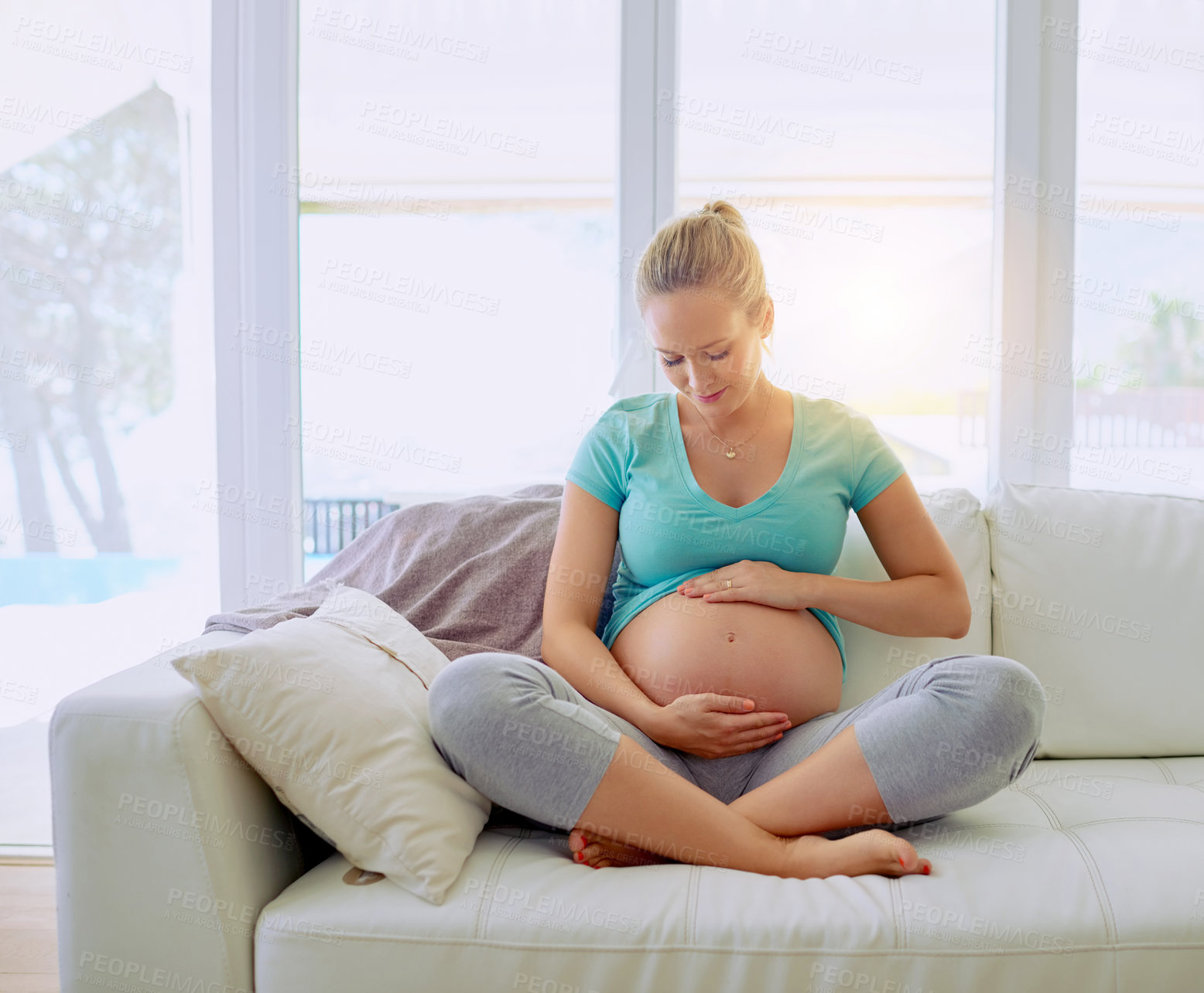 Buy stock photo Relaxing, smile and pregnant woman on sofa in home holding belly for maternity care with happiness. Love, rest and maternal female person with stomach from Australia in living room at apartment.