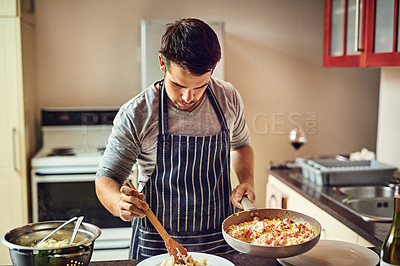 Buy stock photo Shot of a young man preparing food in the kitchen at home