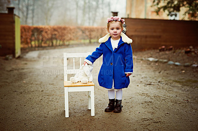 Buy stock photo Shot of an adorable little girl holding her teddy outdoors