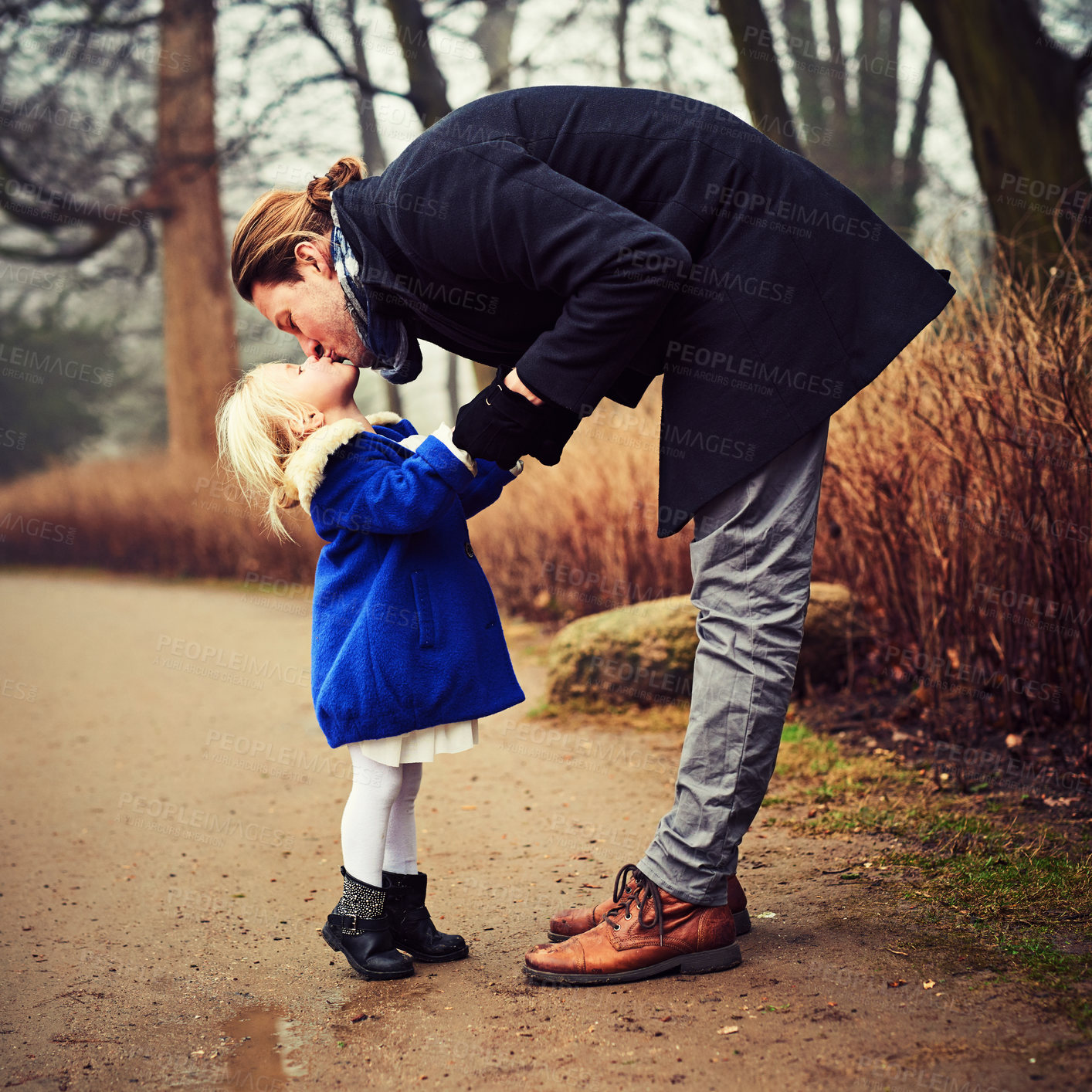 Buy stock photo Winter, kiss and dad in park with girl or support for outdoor fun, love or bonding together. Holding hands, single parent or father with child, daughter or care in cold weather with safety or trust