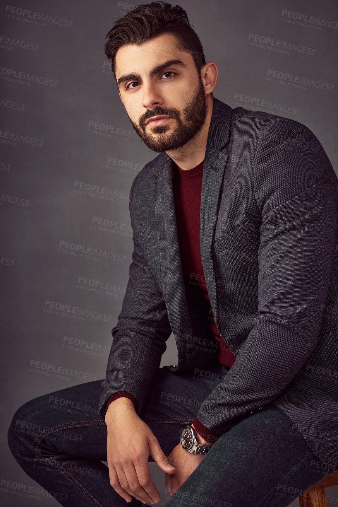 Buy stock photo Studio portrait of a handsome young man posing against a dark background