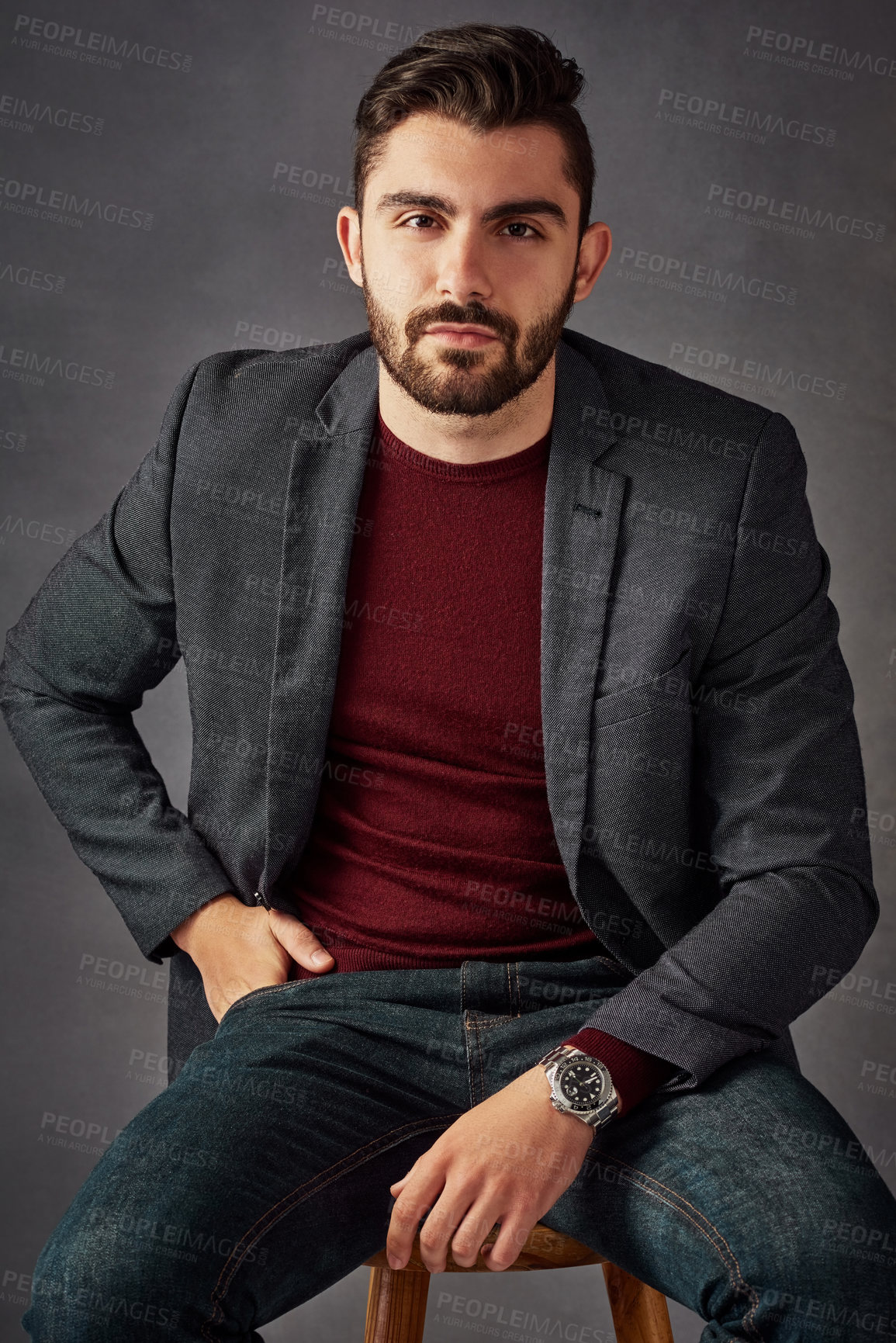 Buy stock photo Portrait, man and confident on stool in studio with casual clothes, trendy fashion and suit jacket as real estate agent. Business, person and chair for investment, property advice and grey background