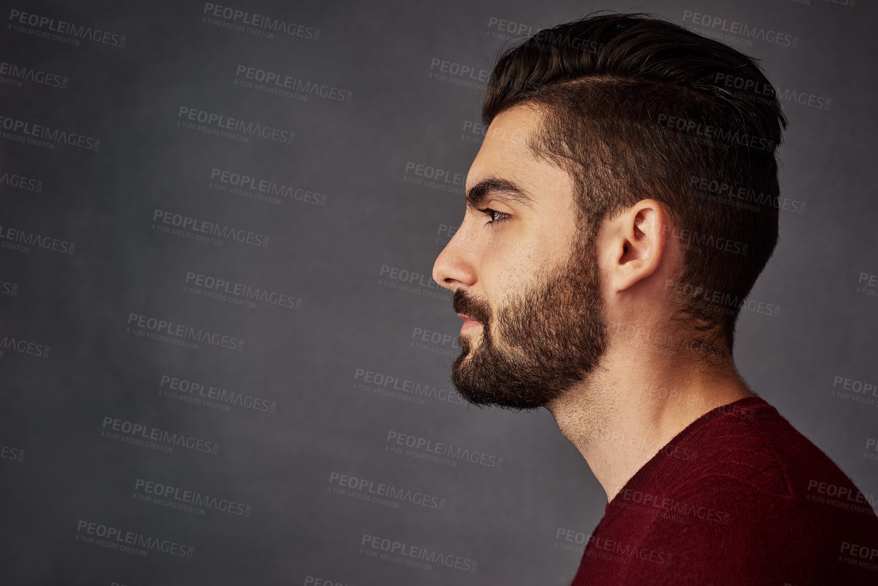 Buy stock photo Studio shot of a handsome young man posing against a dark background