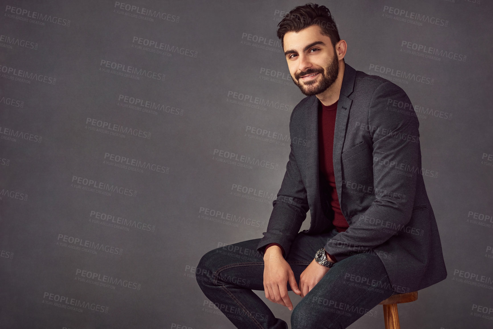 Buy stock photo Studio portrait of a handsome young man posing against a dark background