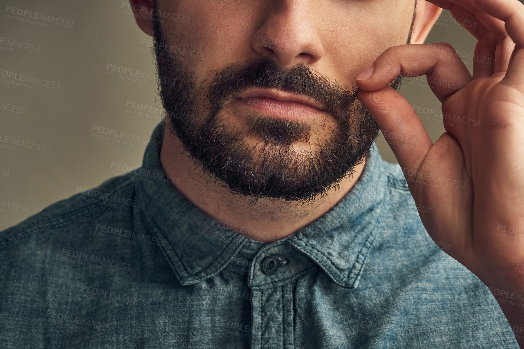 Buy stock photo Man, face and twirl mustache in studio for grooming, haircare and styling on dark background. Male barber, hand and fingers pulling hair for aesthetic, growth and beard maintenance or preparation