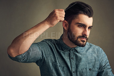 Buy stock photo Man, self care and comb on studio background for grooming, confident haircare and maintenance. Male person, cosmetic tool and brushing for getting ready, treatment and preparation by beauty product