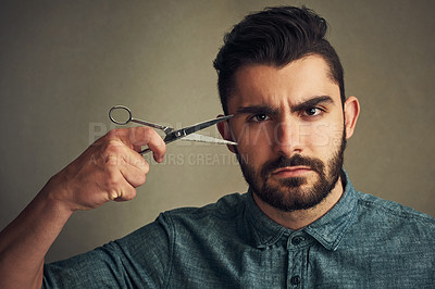 Buy stock photo Man, scissors and barber portrait on studio background, confident and ready for haircut transformation. Male person, grooming kit and serious for cosmetic, maintenance and hairstyle change for growth