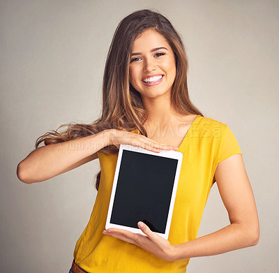 Buy stock photo Happy woman, portrait and tablet screen with display for advertising or marketing on a studio background. Female person, brunette or model with smile for technology app, presentation or mockup space