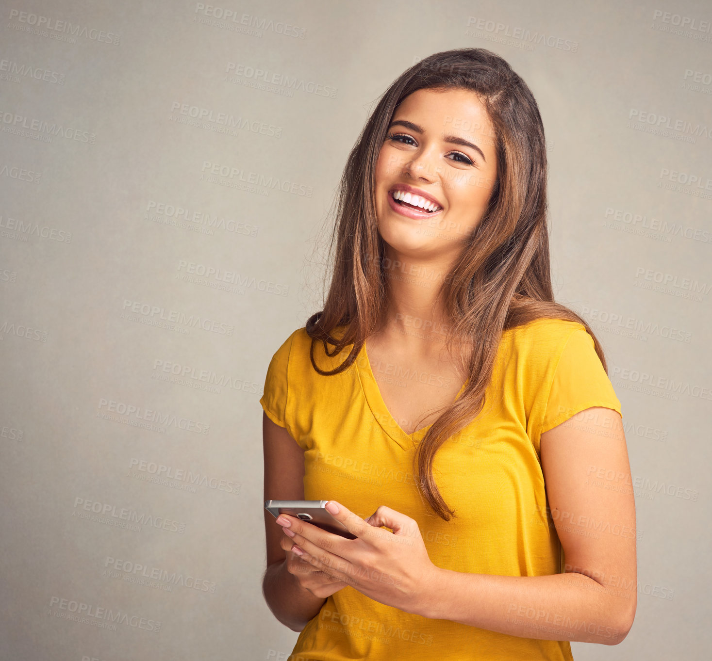 Buy stock photo Studio shot of a beautiful young woman using her digital tablet against a grey background