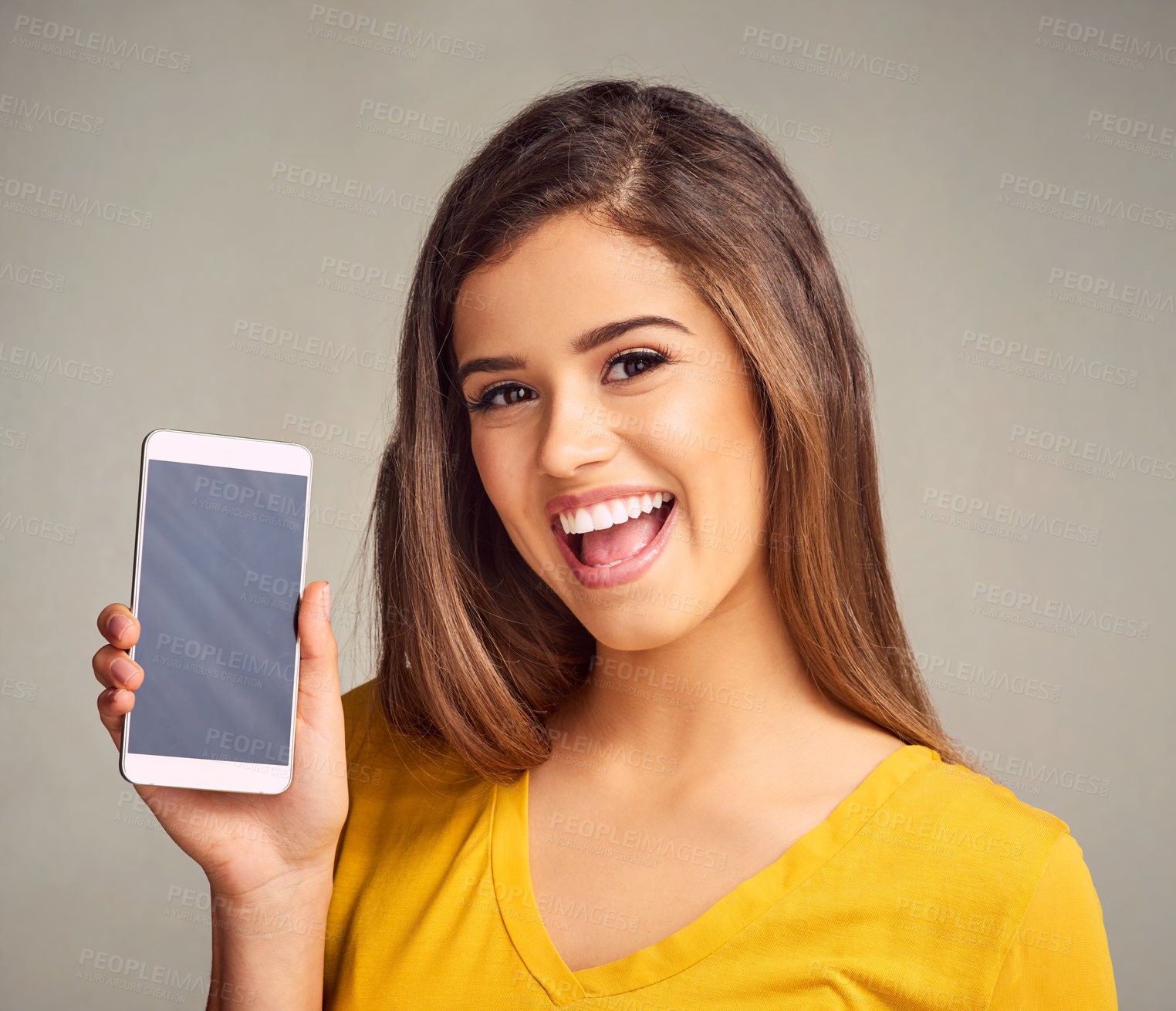 Buy stock photo Portrait, woman and screen of cellphone in studio with mockup space for advertising, marketing or promotion. Smile, technology and female person presenting phone isolated by gray background