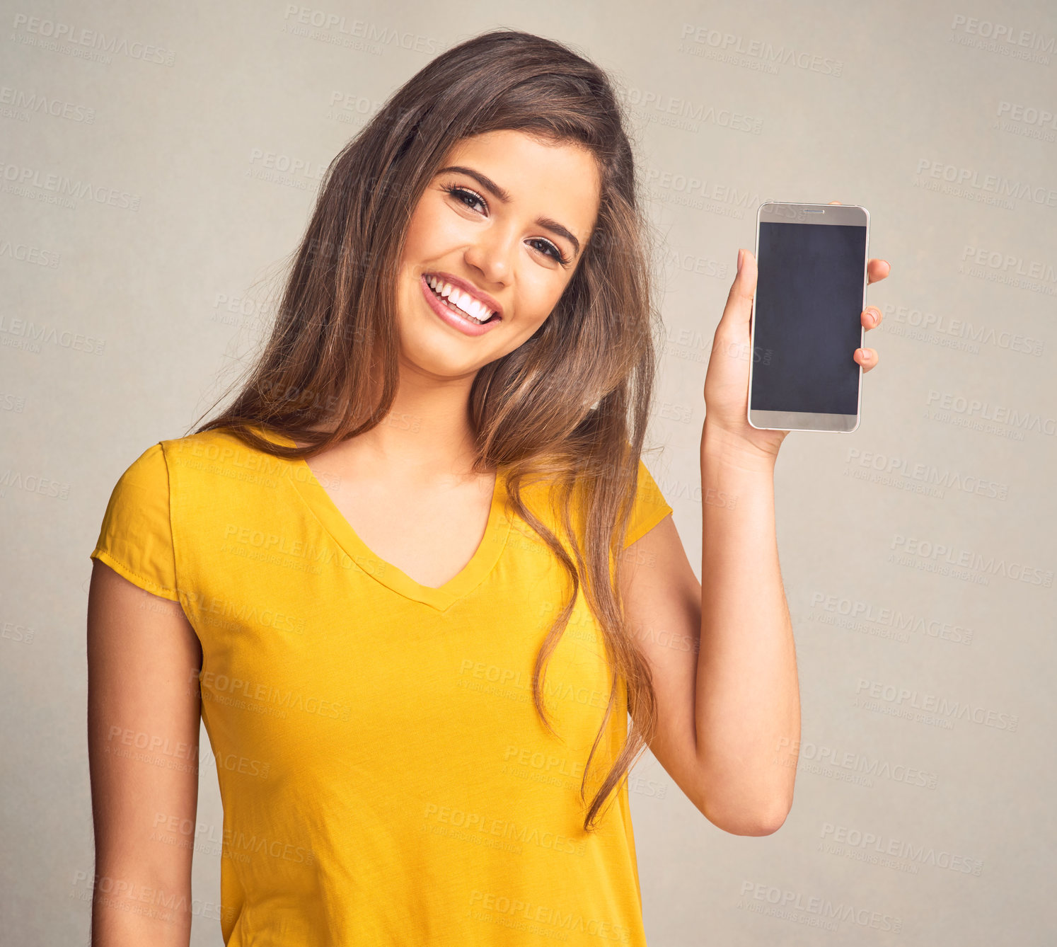 Buy stock photo Portrait, woman and display of cellphone in studio with mockup space for advertising, marketing or promotion. Smile, technology and female person presenting phone screen isolated by gray background