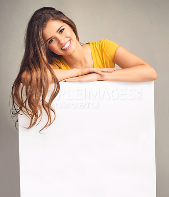 Buy stock photo Mockup space, smile and portrait of woman in studio for news, announcement and information. Happy, advertising and person with sign, bulletin or banner for sale, deal and bargain on grey background