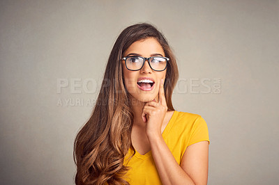 Buy stock photo Closeup of an expressive young woman against a grey background