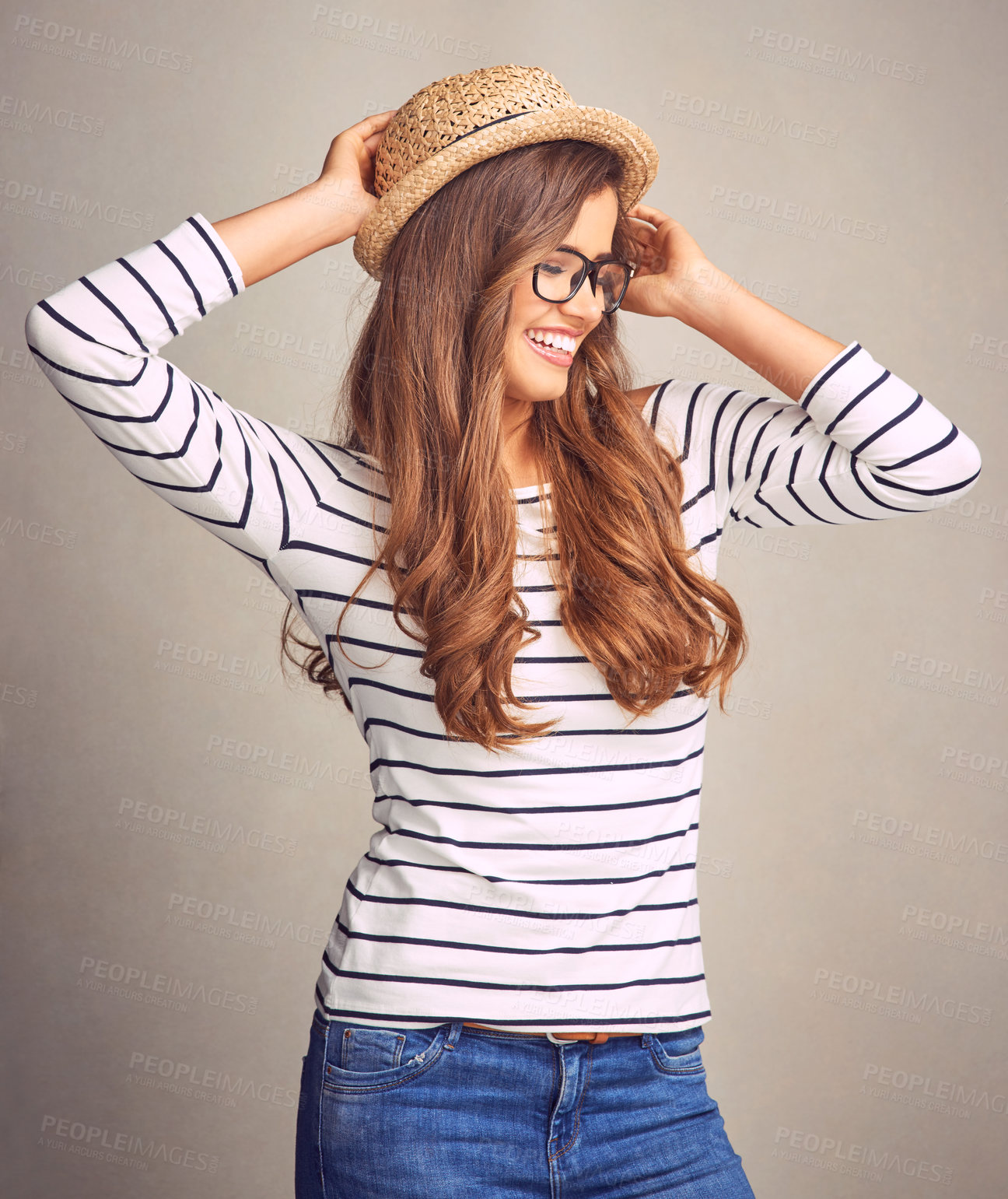 Buy stock photo Woman, laughing and confidence in studio for fashion, cool and trendy outfit with hat, glasses or smile. Female person, model and casual wear on gray background for style, aesthetic and chic clothes