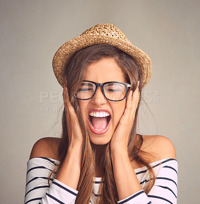 Buy stock photo Studio shot of an attractive young woman screaming against a gray background