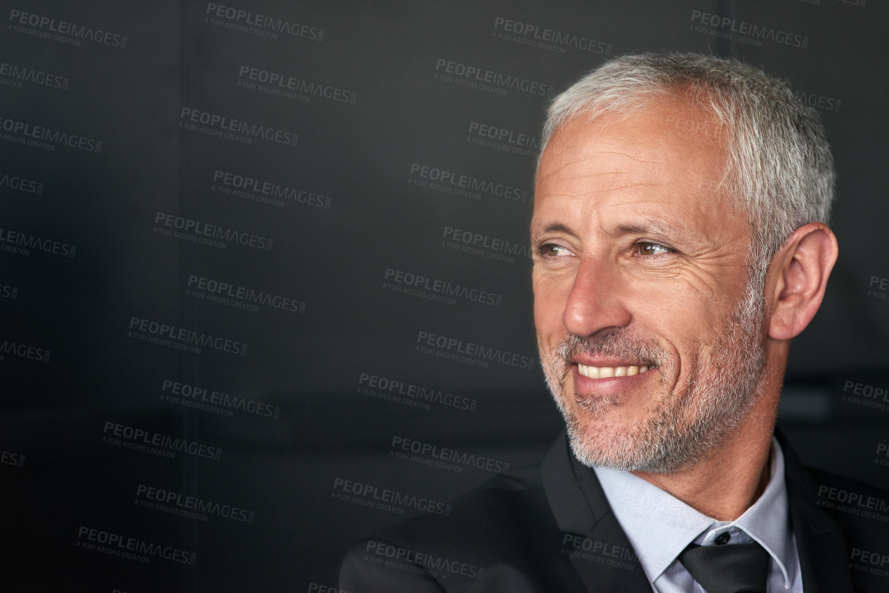 Buy stock photo Cropped shot of a handsome mature businessman standing in the office while looking outside a window