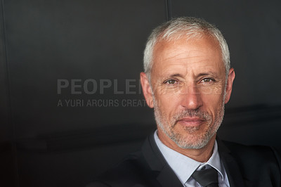 Buy stock photo Cropped shot of a handsome mature businessman standing in the office and looking at the camera