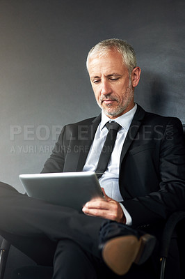 Buy stock photo Man, tablet and research on studio background for business, reading for financial project or crypto. Male manager, mobile technology and planning for stock market, search or review of blockchain app