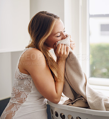 Buy stock photo Smelling, woman and laundry with clothes in basket and happy with clean apartment towel. Female person, cleaning or fabric for self care, lifestyle and happiness in a household with fresh clothing. 