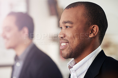 Buy stock photo Cropped shot of two businessmen looking in the same direction while seated outside