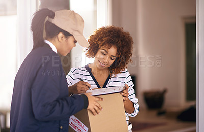 Buy stock photo Shot of a young woman receiving a package and signing it in her home