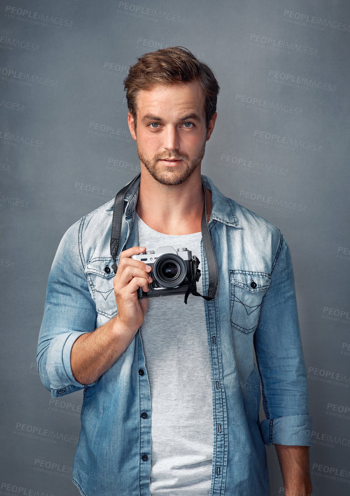 Buy stock photo Camera, photographer and portrait of man in studio for creative art, journalist or photoshoot. Confident, person and photography with lens for artistic, production or digital media on grey background