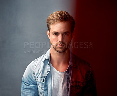 Buy stock photo Portrait of a handsome young man with a brown overlay posing against a gray background in the studio