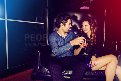 Buy stock photo Happy couple, cheers or laughing in nightclub with cocktails, drinks or champagne for vip event, love or date. People, man or excited woman in dark disco party couch for alcohol, toast or celebration