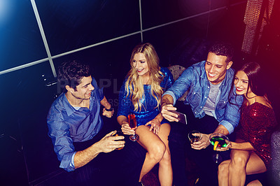 Buy stock photo Shot of a group of friends taking selfies on a mobile phone at a party