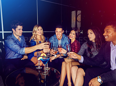 Buy stock photo Shot of a group of friends toasting with drinks at a party