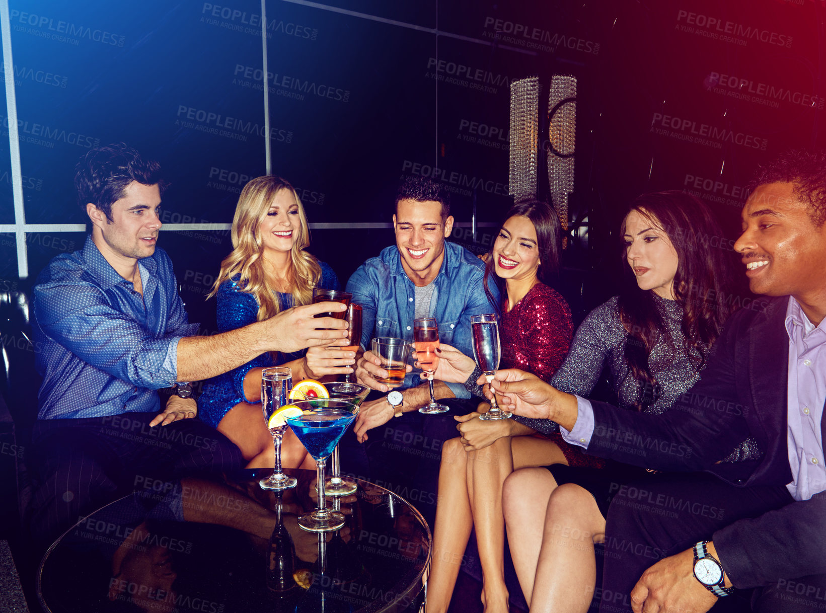 Buy stock photo Shot of a group of friends toasting with drinks at a party