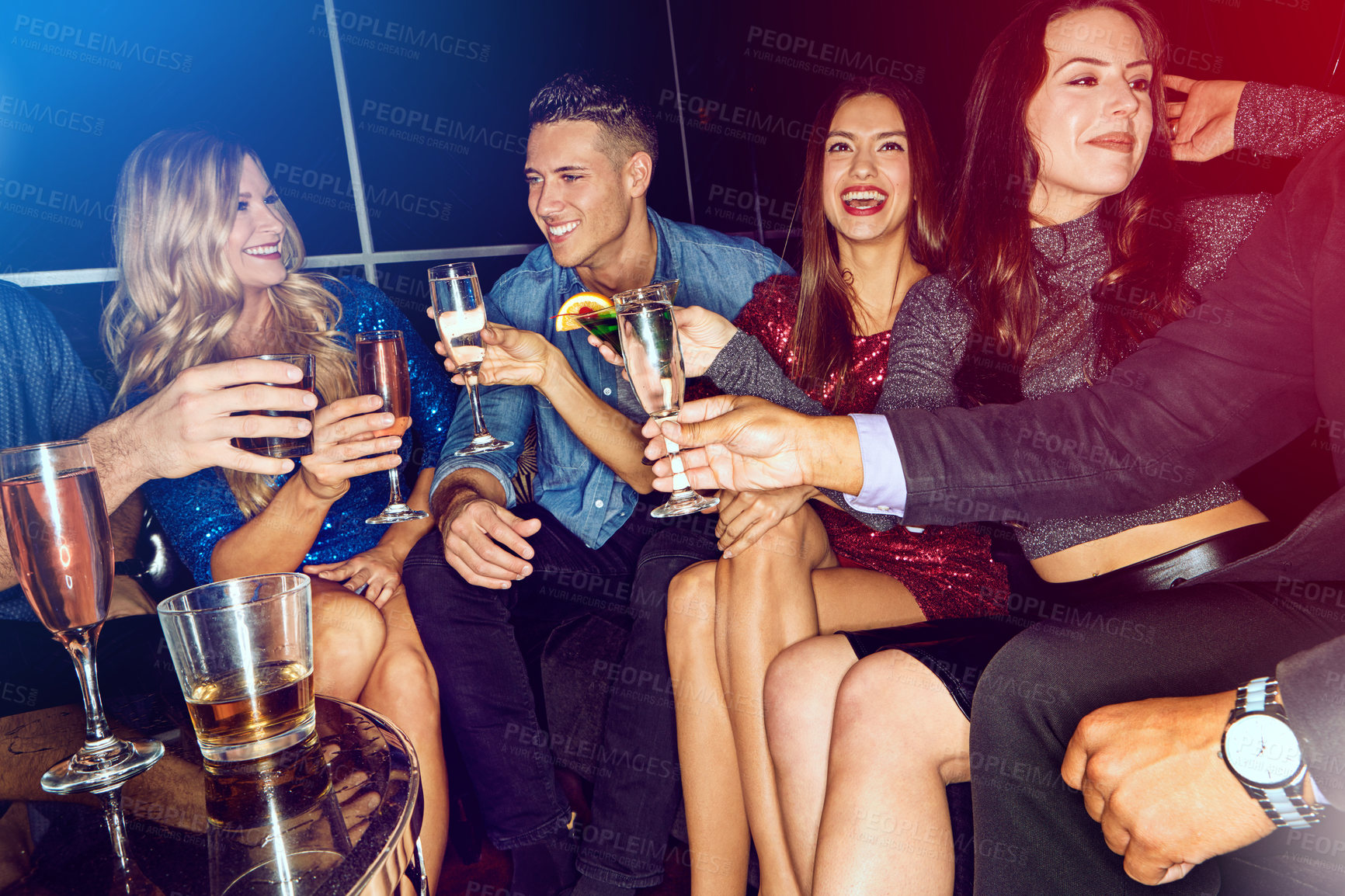 Buy stock photo Shot of a group of friends toasting with drinks at a party