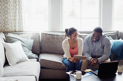 Buy stock photo Happy couple, paperwork and on the sofa together or using laptop for bills or invoice and notebook for tax at home. Accounting, young family and on laptop or couch in the house or mortgage documents