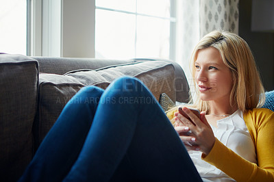 Buy stock photo Morning, thinking and woman in living room, phone and rest on couch, smile and social media in house. Relax, calm and girl with mobile, happy and peace in lounge, cozy and person in apartment