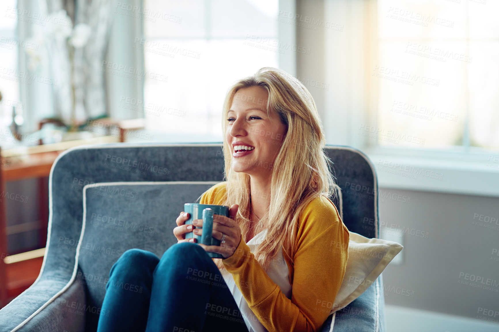 Buy stock photo Home, laughing and woman with coffee, sofa and relax in weekend, morning and break in living room. House, couch and person with tea, peace and smile for rest in lounge, calm and happiness with drink