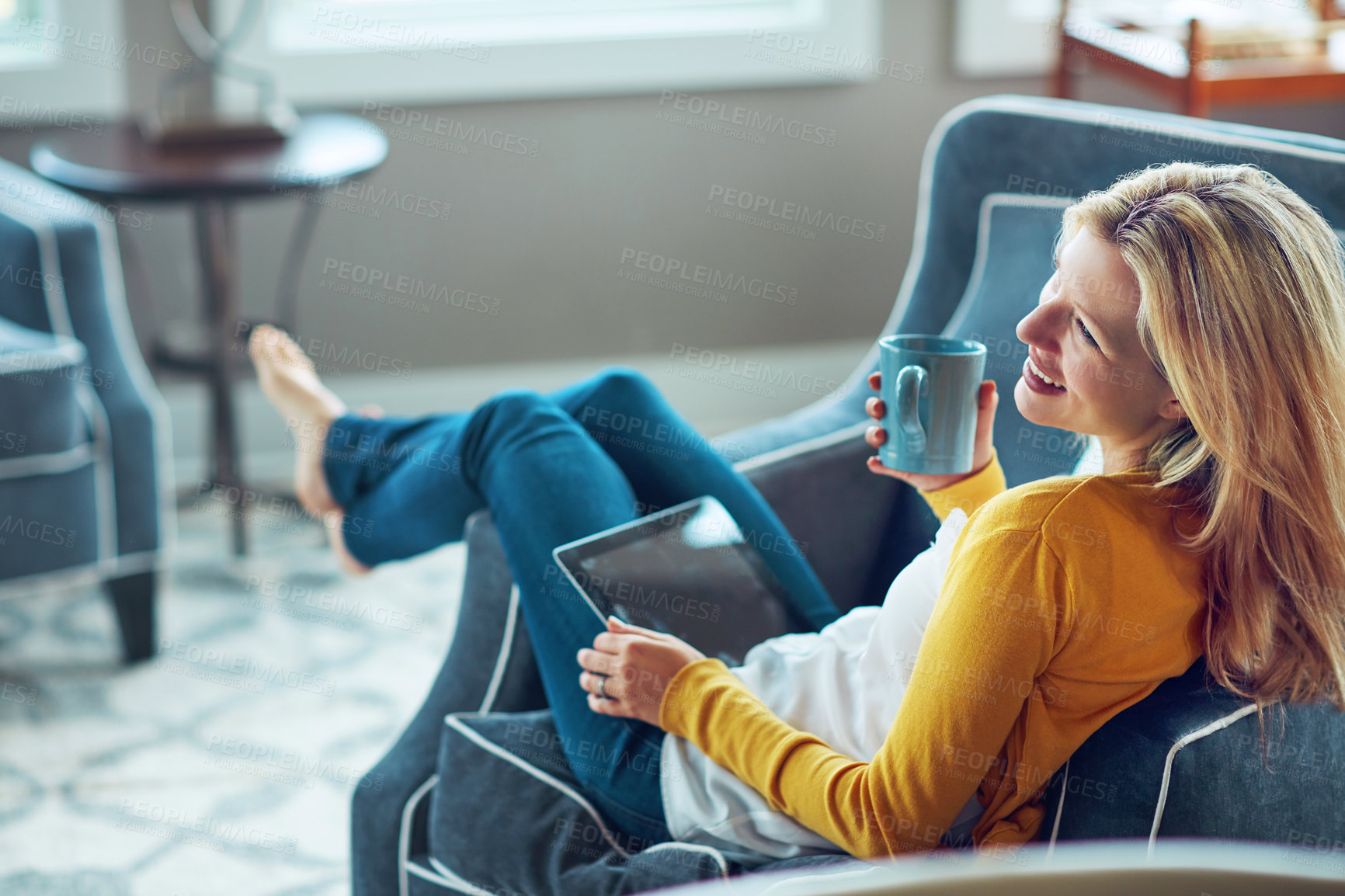 Buy stock photo Happy, tablet and woman on couch, coffee and rest in living room, morning and social media in house. Relax, calm and girl with mobile, smile or peace in lounge, cozy and person with tea in apartment