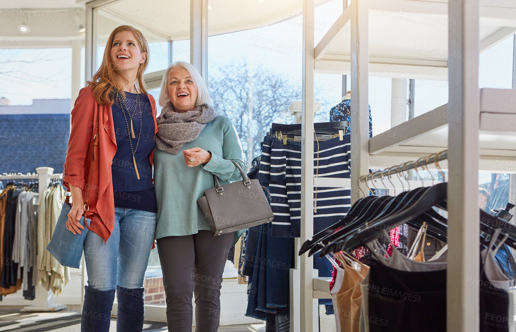 Buy stock photo Senior mother, daughter and shopping at boutique for clothing, sales and bonding together. Surprise, family and elderly woman for outfit selection, collection rack and retail for customer experience