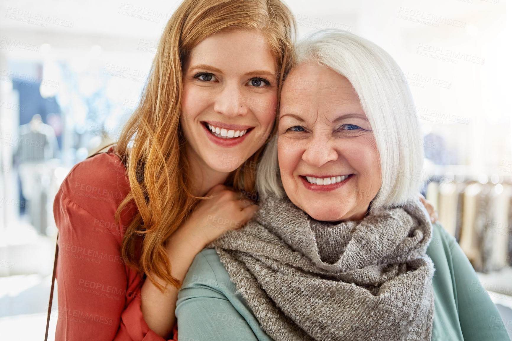 Buy stock photo Shot of a happy young woman standing behind her senior mother