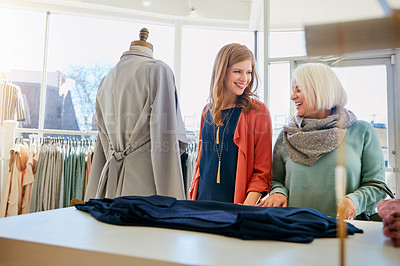 Buy stock photo Shot of a mother and daughter shopping in a clothing boutique