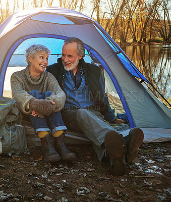 Buy stock photo Old couple, tent and camping with nature, relax and vacation with retirement, getaway trip or break. Outdoor, senior man or mature woman with sunshine, mountains or holiday with conversation or relax