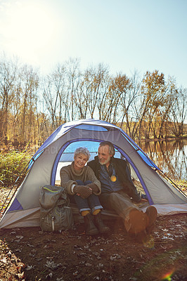 Buy stock photo Shot of a senior couple camping together in the wilderness