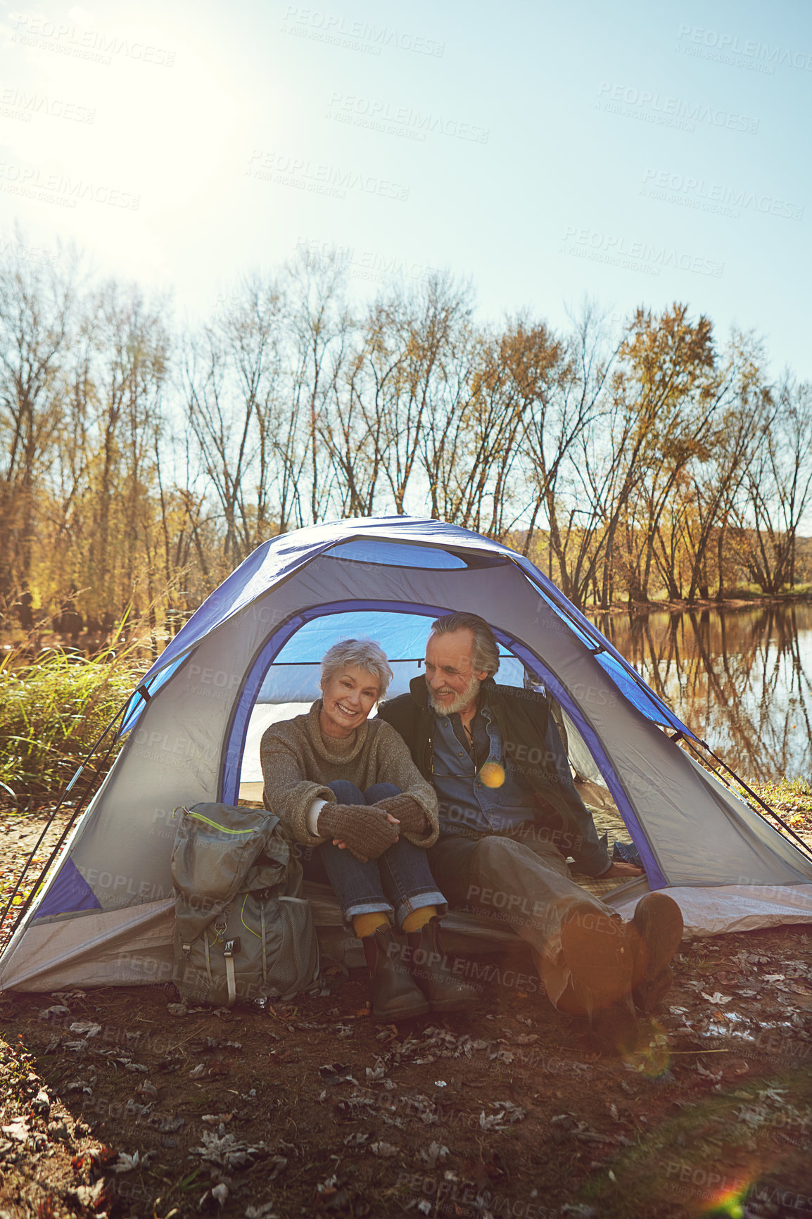 Buy stock photo Shot of a senior couple camping together in the wilderness